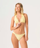 Buttercup Lace Halter Top in pastel yellow with hand-cut lace detailing and adjustable neck tie.