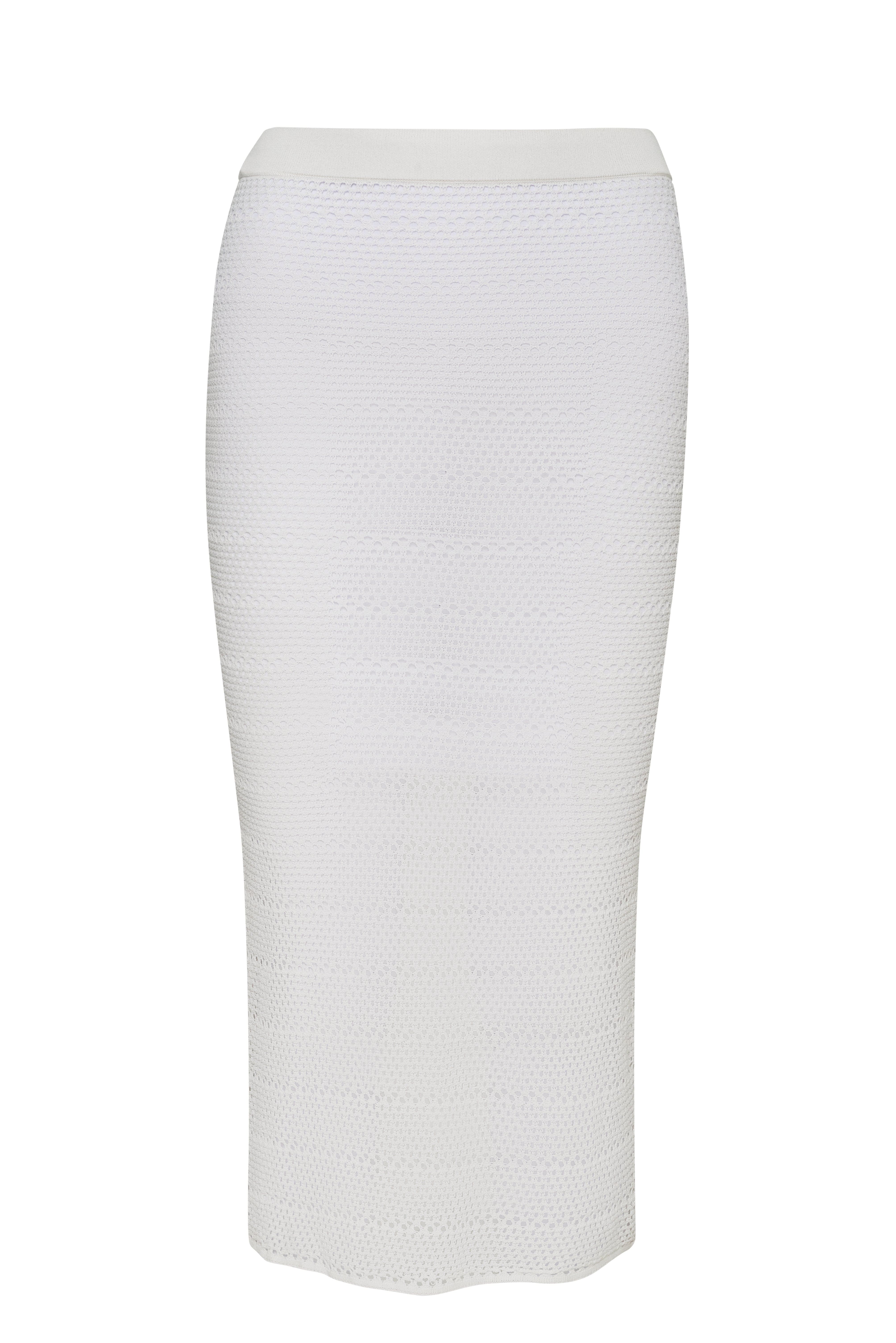 Long, white, knit skirt in front of a white background. 