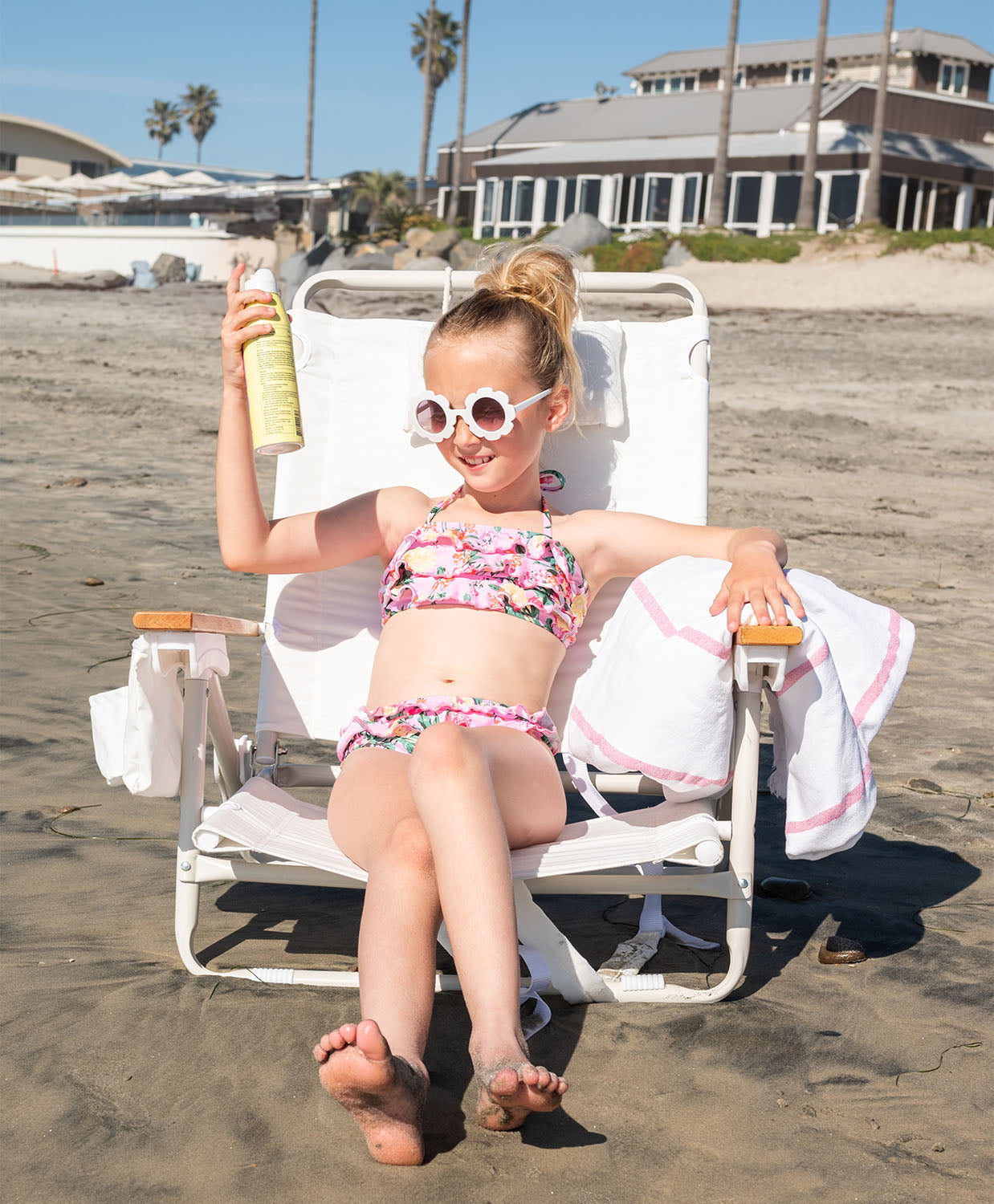 Kids Dahlia Ruffle Bikini – pink floral two-piece swimsuit with bold ruffles and adjustable neck ties.