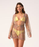 Woman wearing a yellow bikini with a matching cover-up against a white background