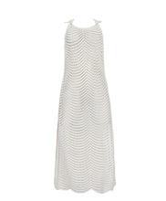 An ivory sleeveless cover up with scalloped lace detailing. Featured against a white wall background.