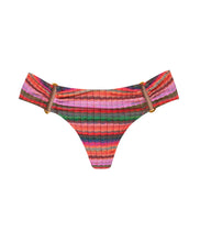 A multi-colored stripe print fanned bikini bottom with gold details. Featured against a white wall background.