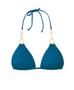 A textured turquoise triangle shape bikini top with gold details. Featured against a white wall background.