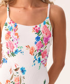 Model wearing the Smocked Elodie One Piece swimsuit in a vibrant floral print