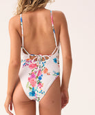 Model wearing the Smocked Elodie One Piece swimsuit in a vibrant floral print
