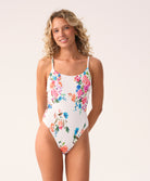Model wearing the Smocked Elodie One Piece swimsuit in a vibrant floral print