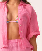 Hot pink linen shorts with a relaxed fit and flattering silhouette, designed for comfort and warm-weather style.