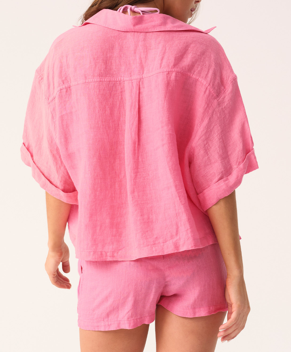 Hot pink linen shorts with a relaxed fit and flattering silhouette, designed for comfort and warm-weather style.