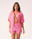 Hot pink linen shorts with a relaxed fit and flattering silhouette, designed for comfort and warm-weather style.