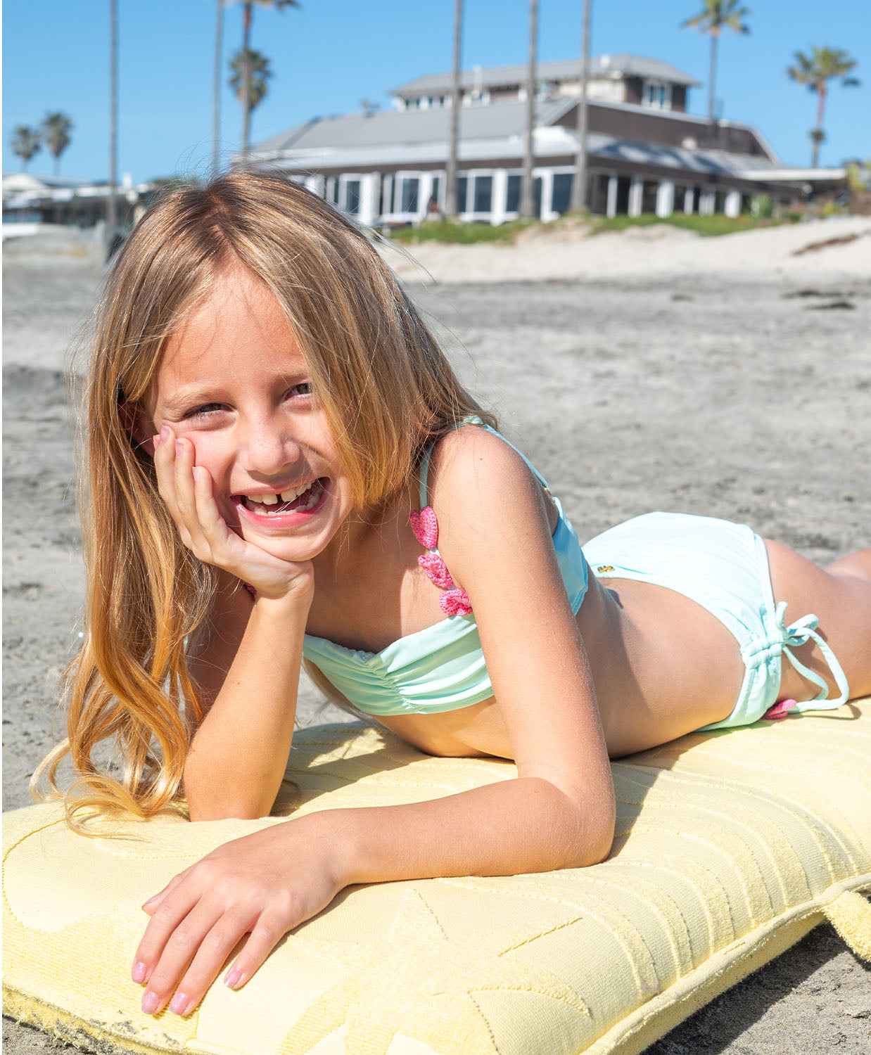 Kids Aqua Hearts Bikini with pink heart embroidery and adjustable tie straps, a playful aqua two-piece for sunny days.