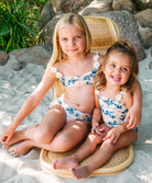 Kids Blossom Evie Flower Bikini two-piece with floral print, crochet flower straps, and ruched tie bottoms for a playful fit.