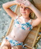 Kids Blossom Evie Flower Bikini two-piece with floral print, crochet flower straps, and ruched tie bottoms for a playful fit.