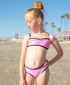 Kids Candy XOXO Bikini in soft pink with black trim and beaded XOXO strap detail.
