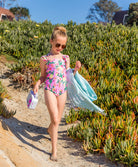 Kids Dahlia Maddie Bow One Piece swimsuit with vibrant pink floral print and bow strap details.