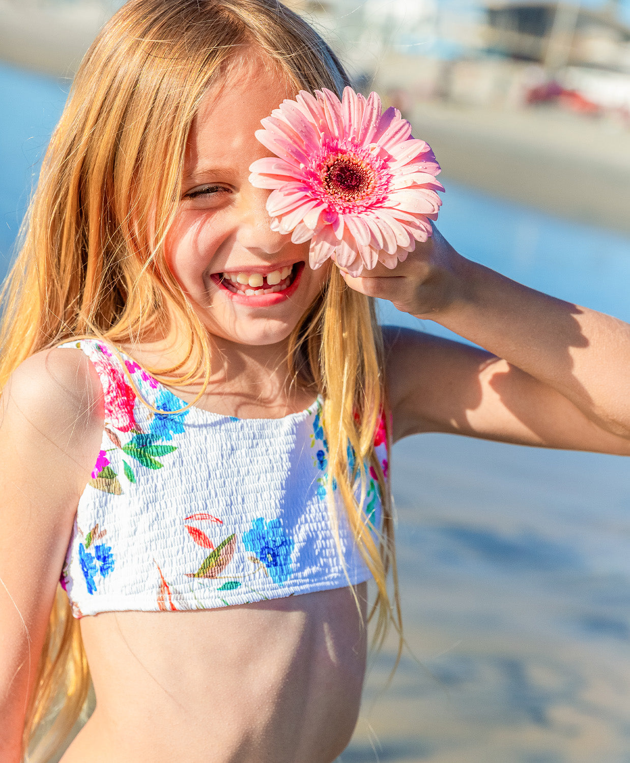 Kids Florencia Finley Bikini in soft white smocked fabric with vibrant floral patterns, designed for a playful and adorable beach look.