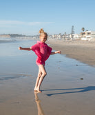 Kids Hot Pink Reagan Poncho with cozy hood and drawstrings, perfect for breezy beach days and post-swim comfort.