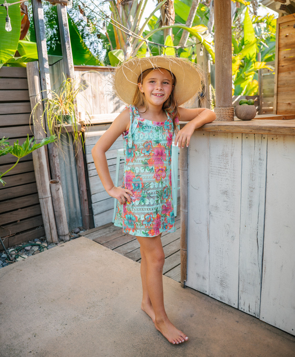 Kids Solana Grace Tie Dress in blue tropical floral print with adjustable tie straps and playful crochet design.