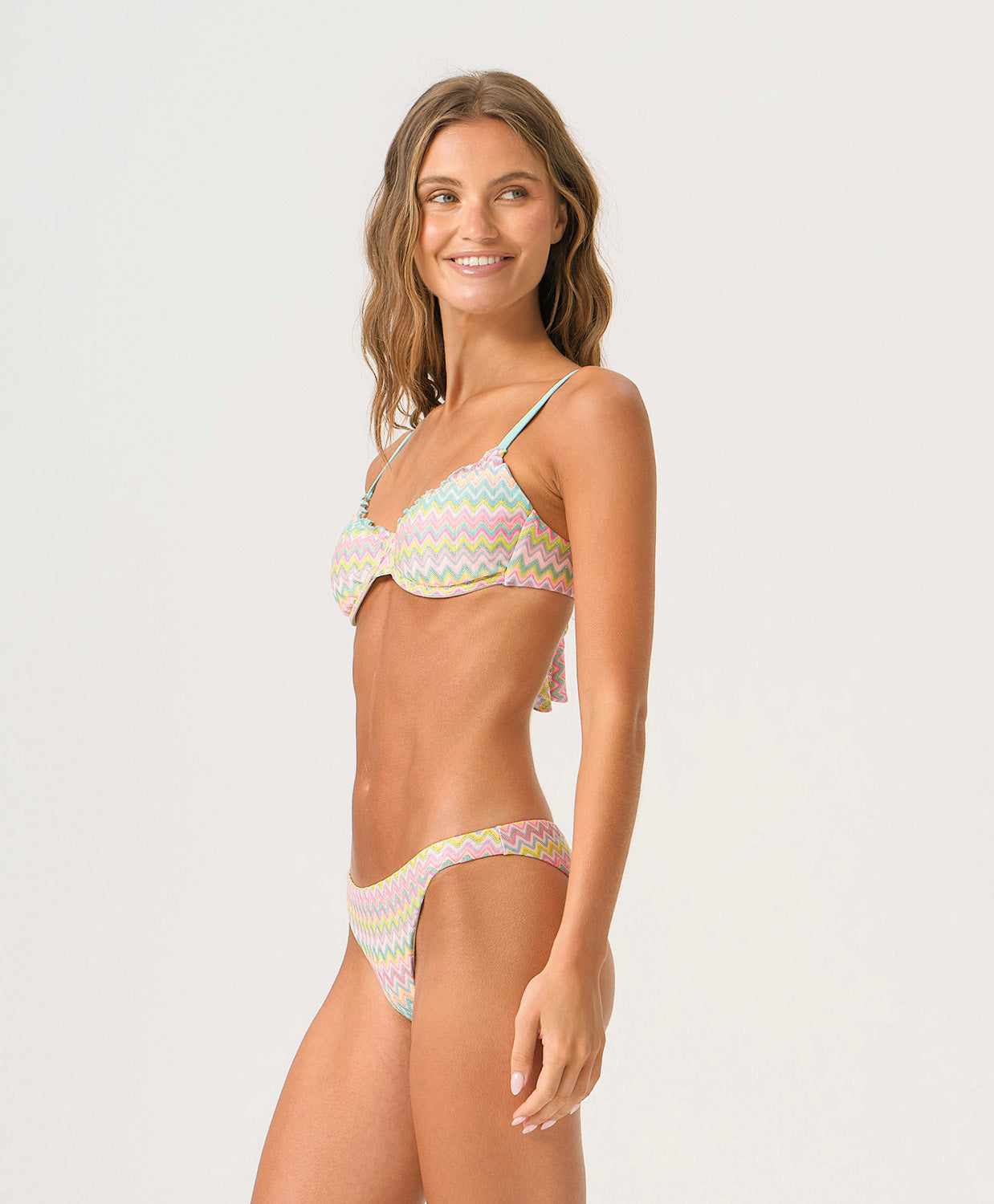 Love Spell Basic Ruched Bottom bikini bottom with shimmering pastel chevron print and flattering ruched back.