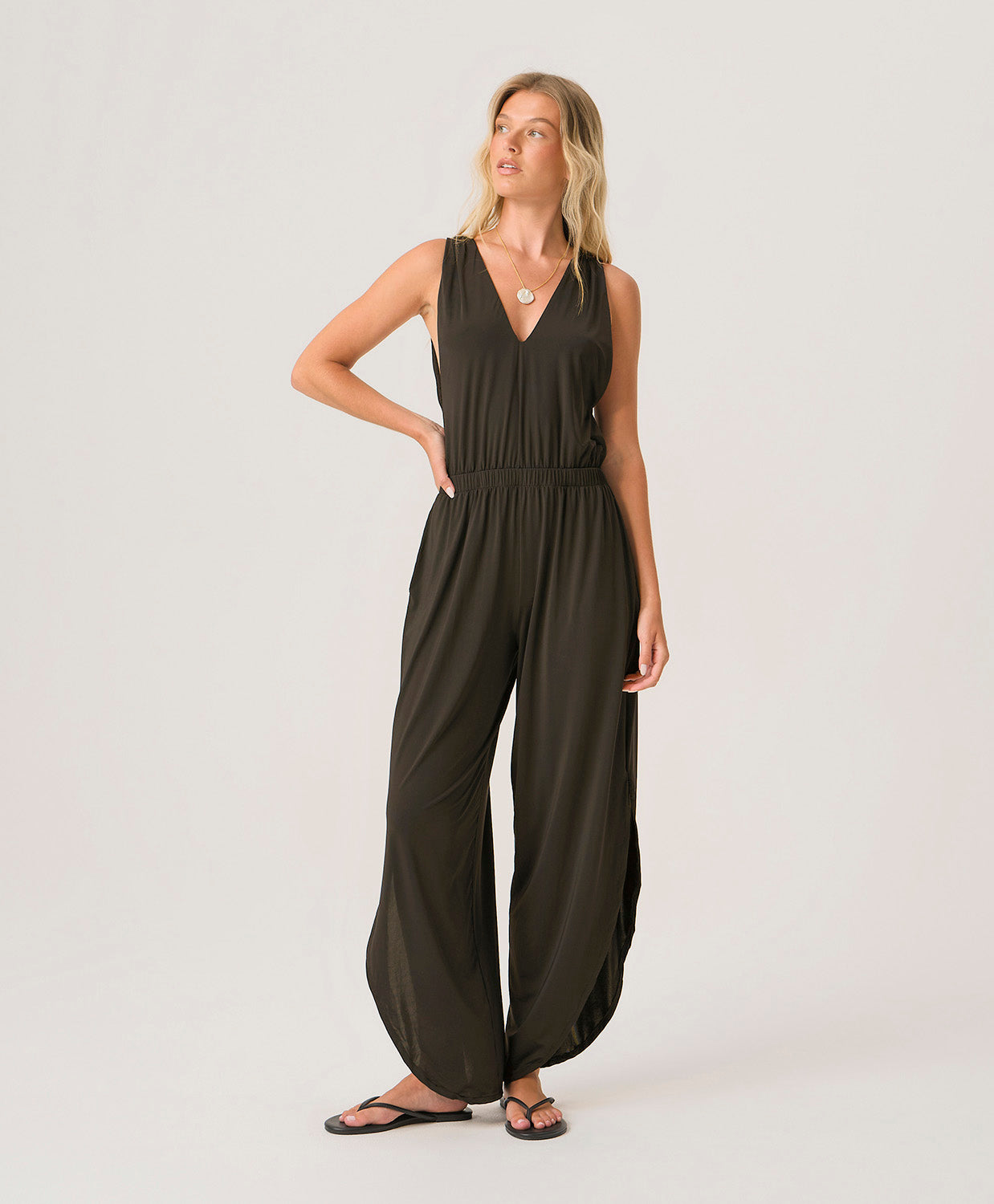 Midnight Joanne Jumpsuit in silky draped fabric with V-neckline, cinched waist, and adjustable back ties for an elegant full-length look