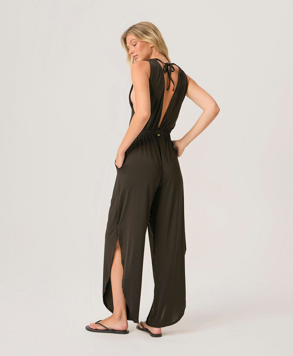Midnight Joanne Jumpsuit in silky draped fabric with V-neckline, cinched waist, and adjustable back ties for an elegant full-length look