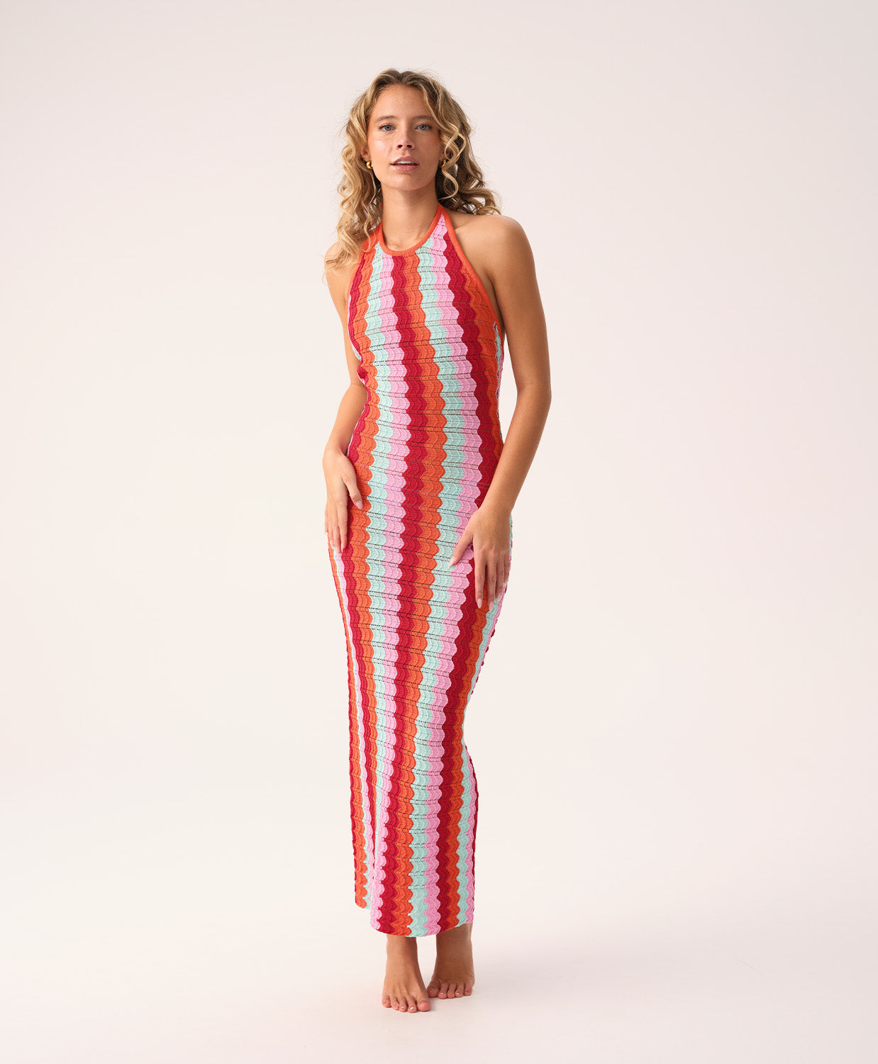 Floor-length multicolor crochet dress with a low back and halter neck ties, called the Milos Aurelia Dress.