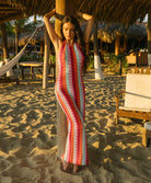Floor-length multicolor crochet dress with a low back and halter neck ties, called the Milos Aurelia Dress.