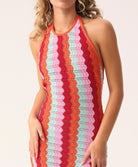 Floor-length multicolor crochet dress with a low back and halter neck ties, called the Milos Aurelia Dress.