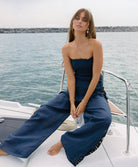 Navy Jace Lace Pant in airy navy linen with hand-cut lace side panels and a ruched waistband for a feminine, resort-ready look.