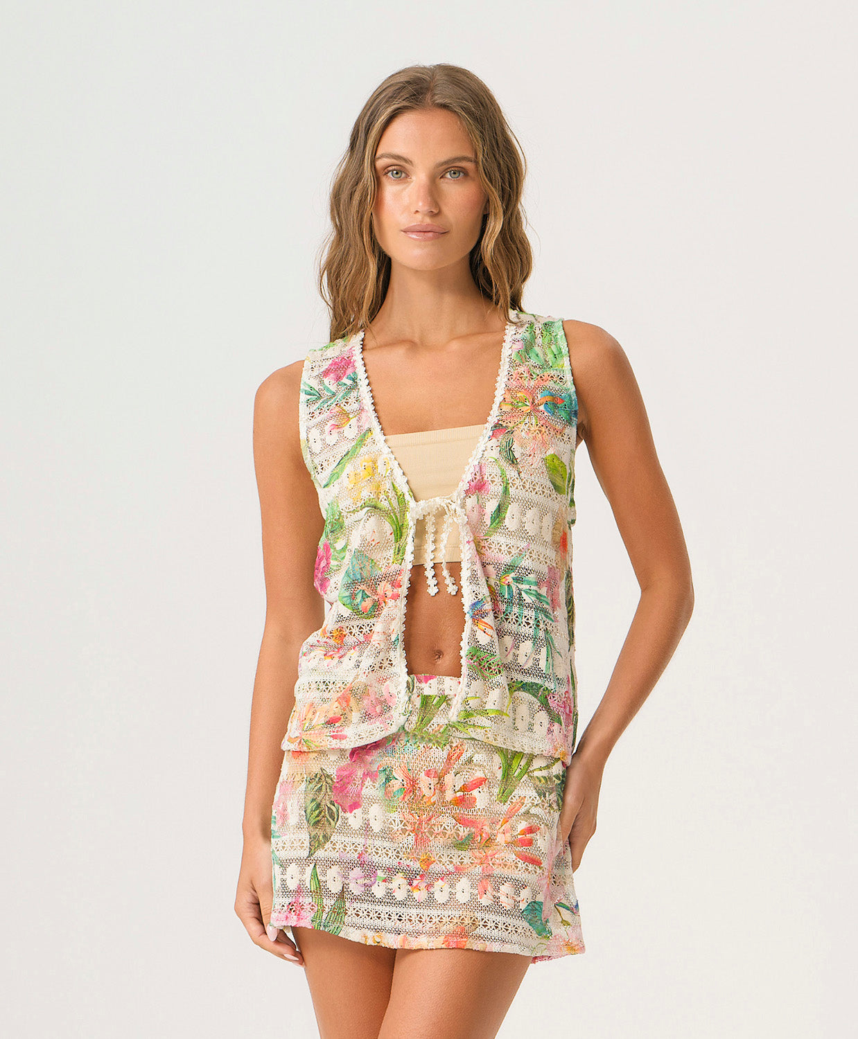 Paradise Bloom Leni Top in printed crochet fabric with tropical floral print, lace trim, and center tie closure.