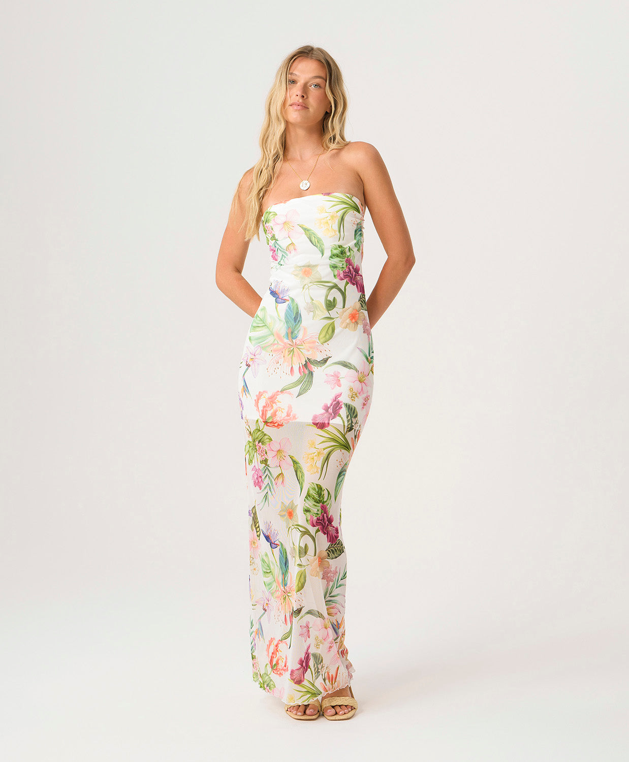 Paradise Bloom Sofia Tube Dress strapless floor-length dress with tropical floral print, sheer hem, and subtle back slit.