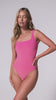 A woman wearing a pink square neck one piece bathing suit spinning in front of a white background.