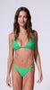 A woman wearing a green triangle bikini set with twisted rope accent straps spinning in front of a white background.