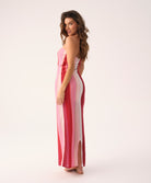 Scarlet Jane strapless dress with vibrant pink, red, and white chevron pattern and gold lurex shimmer, featuring a back slit.