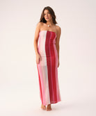 Scarlet Jane strapless dress with vibrant pink, red, and white chevron pattern and gold lurex shimmer, featuring a back slit.
