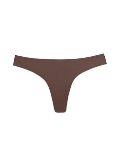 A brown bikini bottom against a white wall.