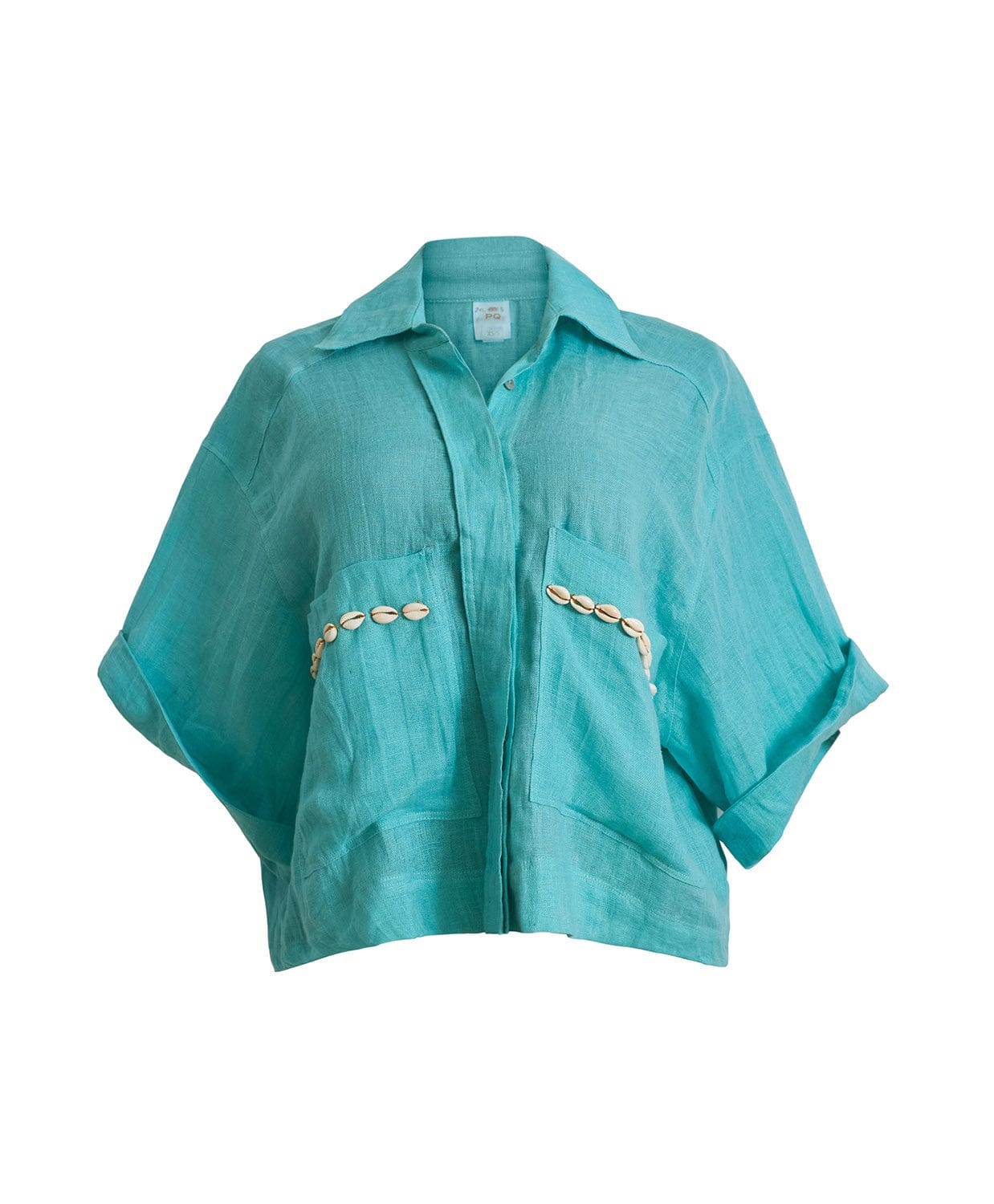 A teal button down shirt against a white wall. 