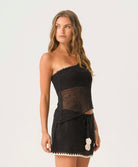 black crochet mini skirt with white flower appliqué ties, adjustable fit, resort-ready style