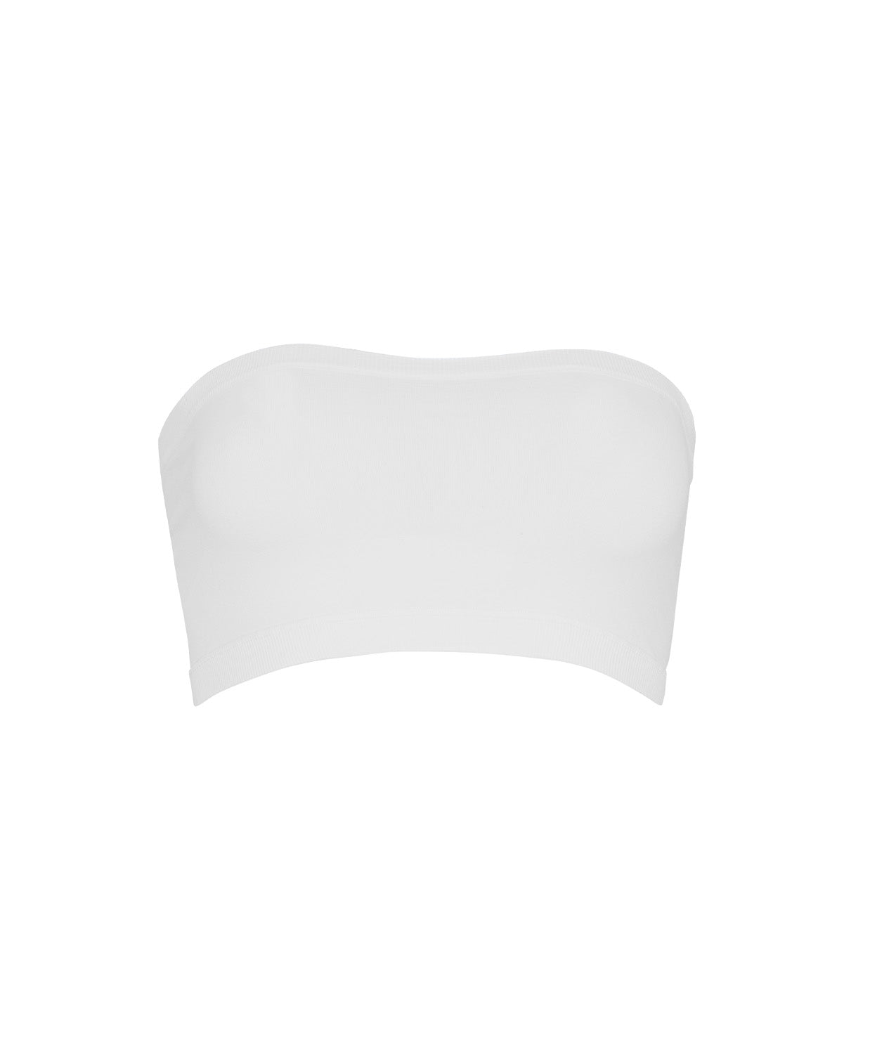 A woman wearing a white bandeau and matching shorts standing against a white wall. 