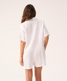 White linen romper with a collared neckline and front buttons