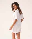 White linen romper with a collared neckline and front buttons