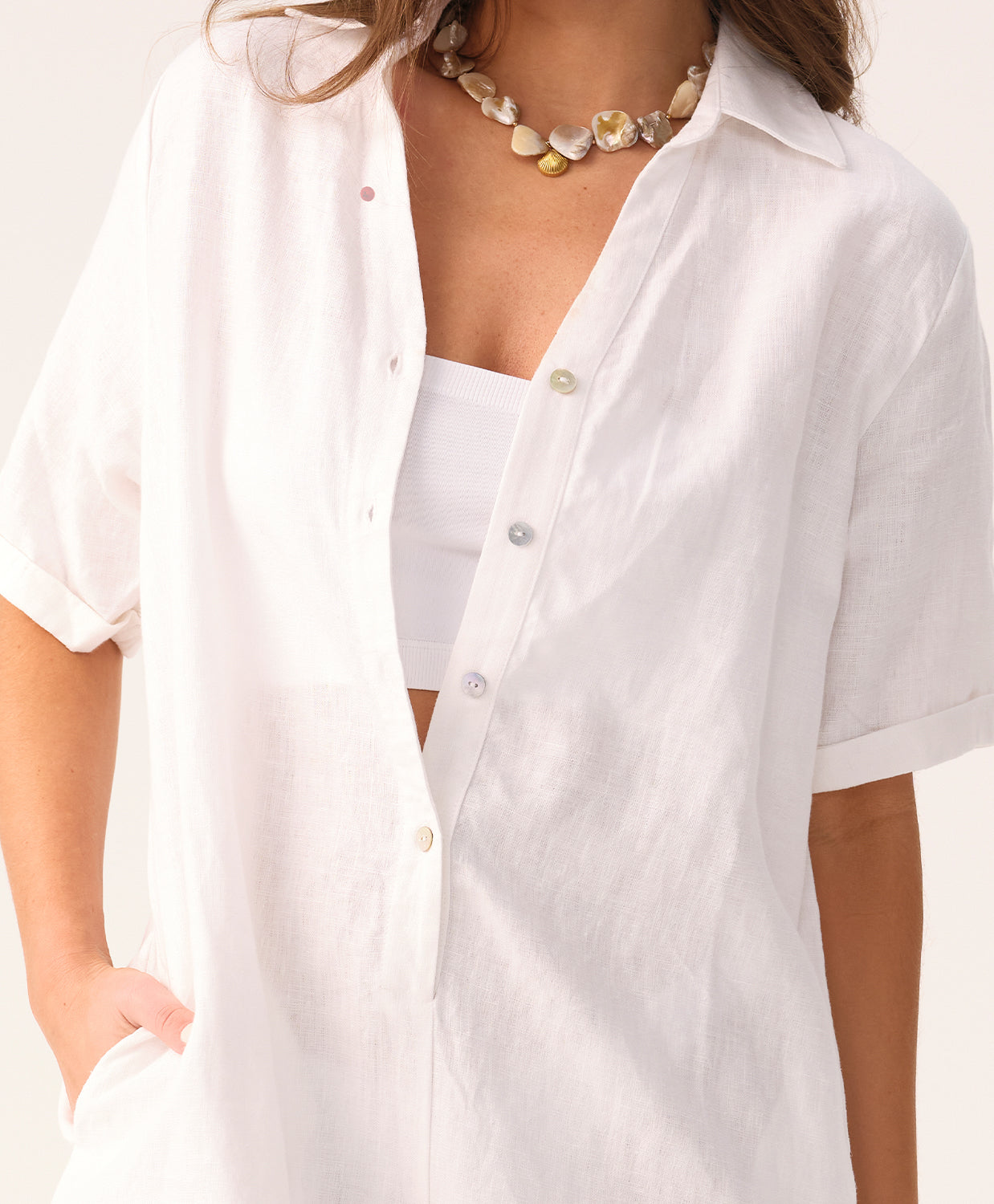 White linen romper with a collared neckline and front buttons