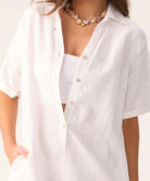 White linen romper with a collared neckline and front buttons