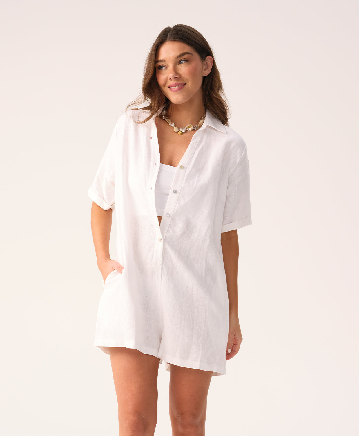 White linen romper with a collared neckline and front buttons